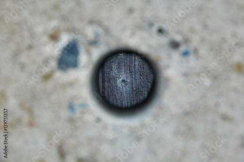 Hole in a concrete fence.