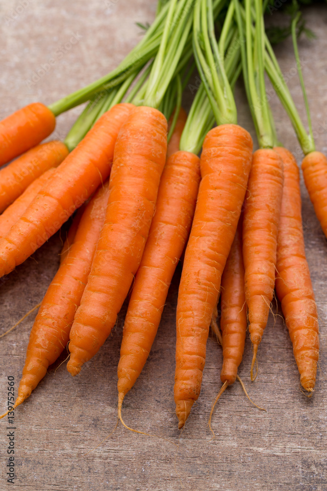 Fresh and sweet carrot on a grey wooden table. Fresh and sweet carrot on a grey wooden table.