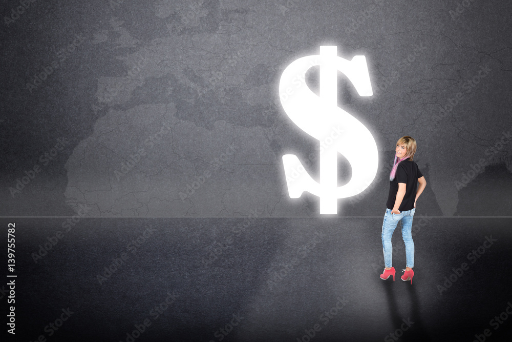 woman standing in front of a portal shaped as a dollar symbol woman standing in front of a portal shaped as a dollar symbol