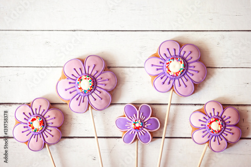 Easter sweets, flower shaped gingerbread cookies on a white wooden table. Happy Easter home-baked cookies 