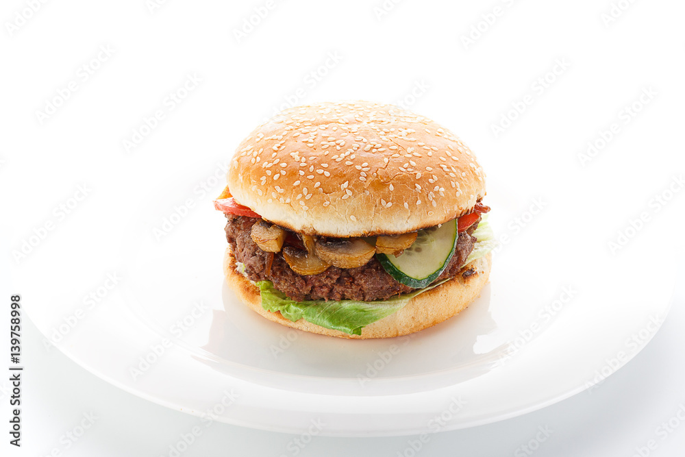 Big burger on a white plate isolated on white background.