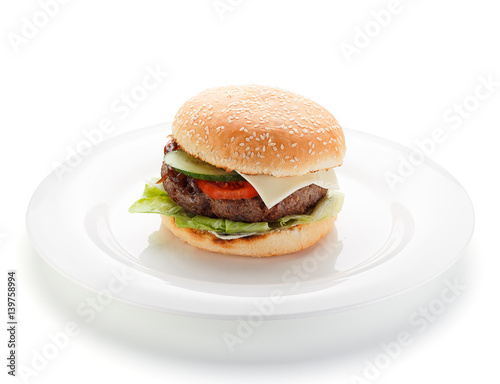 Big burger on a white plate isolated on white background.