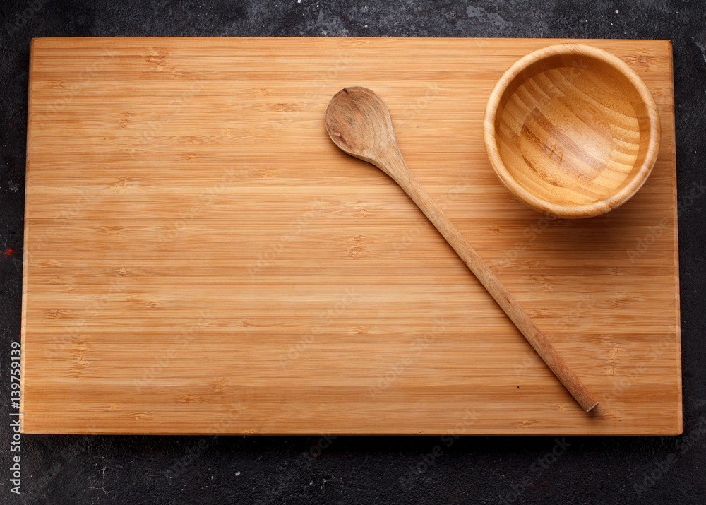 Wooden dishes over dark concrete background Wooden dishes over dark concrete background