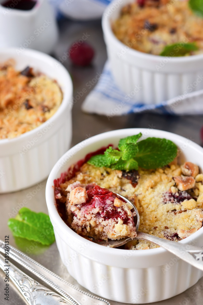 Crumble with berries, oatmeal and nuts on a metallic background Crumble with berries, oatmeal and nuts on a metallic background