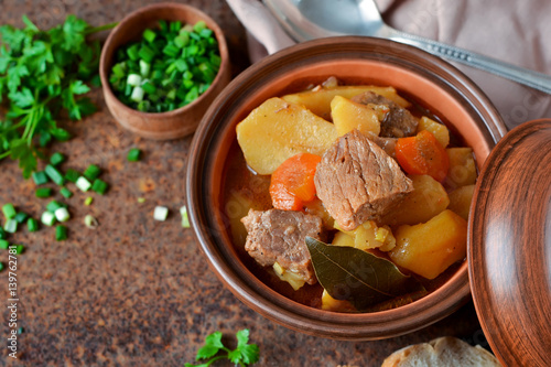 Stew with vegetables and potatoes on an old grunge background
