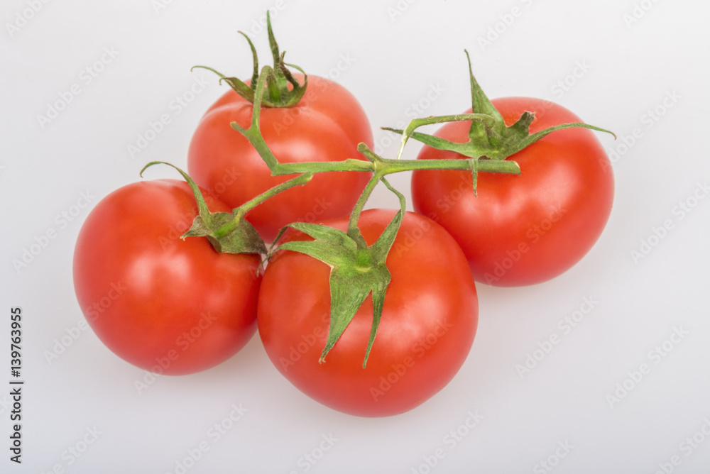 Red tomatoes on a table on a white background