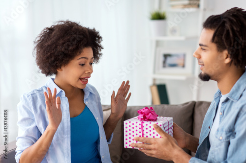 happy couple with gift box at home