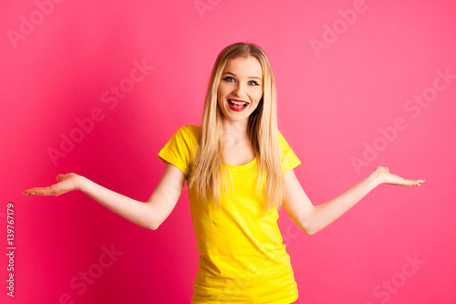 excited young woman over pink background gesture success with arms up in the air © Samo Trebizan