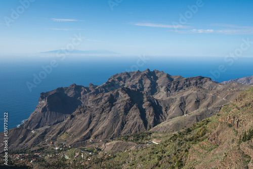 La Gomera landscape, Cliffs and canyons, La Palma island is in the background.