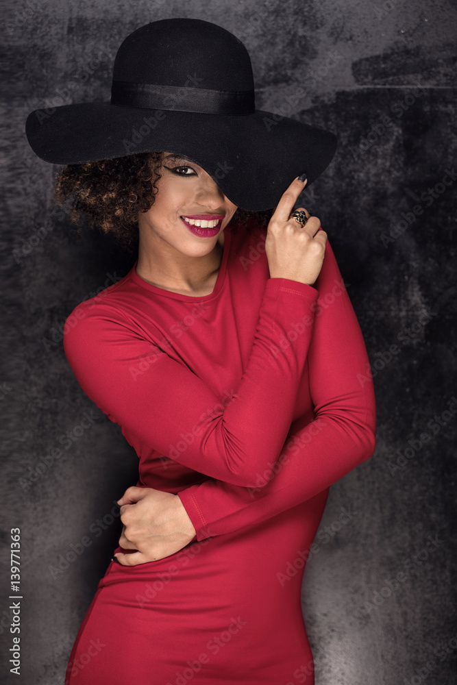 Fashionable girl in black hat posing. Fashionable girl in black hat posing.