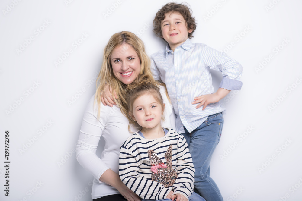 mother, her son and daughter in front of white background