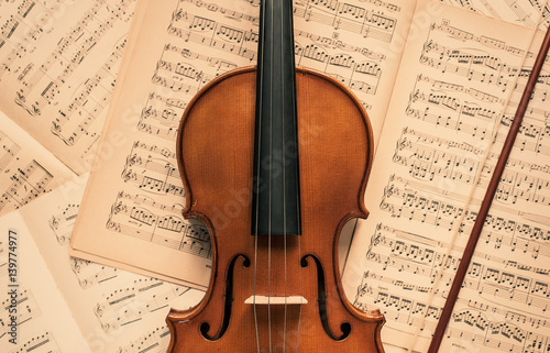 Violin lying on the old music notes