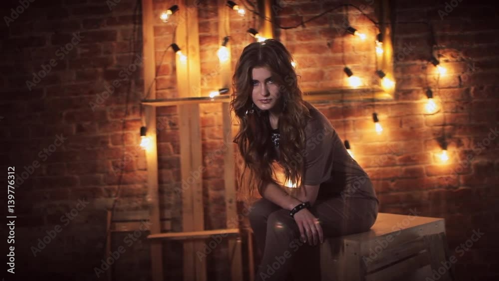 girl on the background of electric lamps and brick wall girl on the background of electric lamps and brick wall