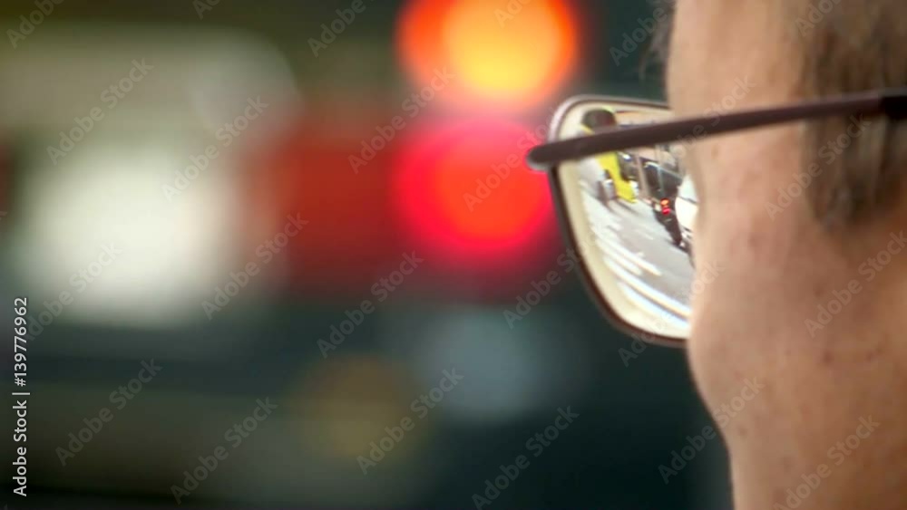 Extreme closeup of man's perspective POV of looking at busy movements through his glasses. Shot in slow motion of POV subject looking around
