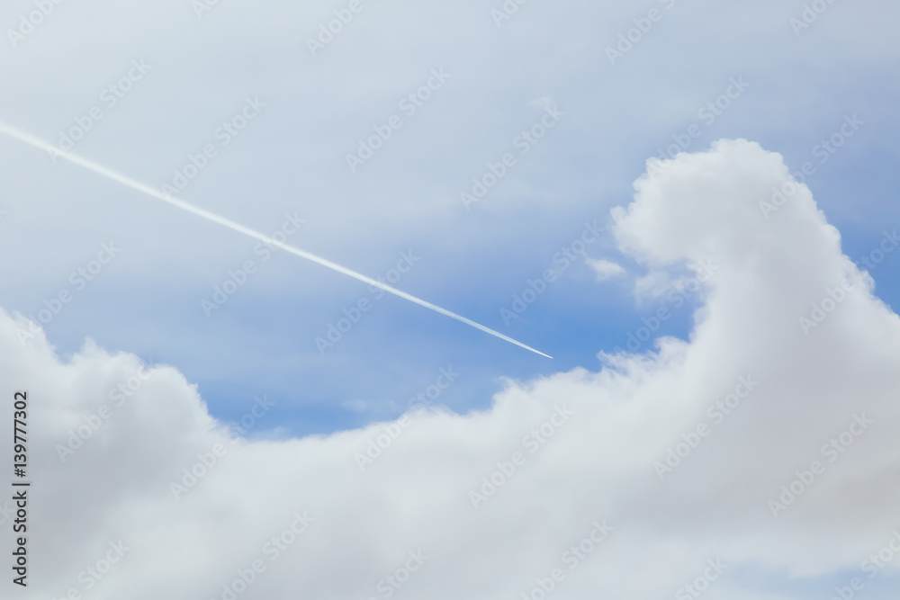 Airplane Streaking Through the Clouded Sky Airplane Streaking Through the Clouded Sky