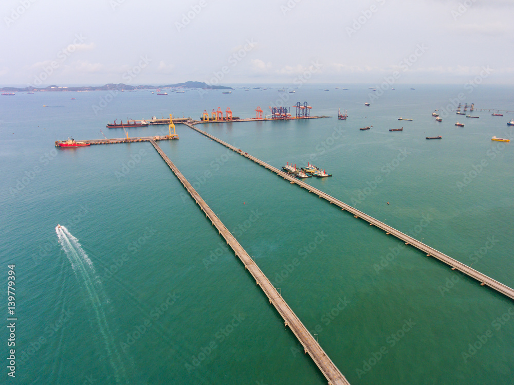 Aerial view of long concrete jetty head into the sea Aerial view of long concrete jetty head into the sea