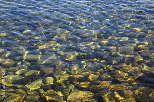 Stones under transparent water, background © Aniland