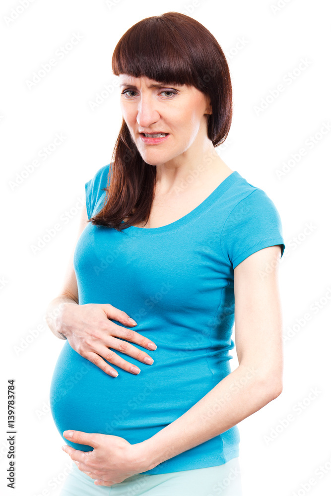 Sad pregnant woman with stomach pain touching her belly, aches in pregnancy and risk of miscarriage Sad pregnant woman with stomach pain touching her belly, aches in pregnancy and risk of miscarriage