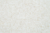 Closeup pile of white rice called jasmine rice textured background