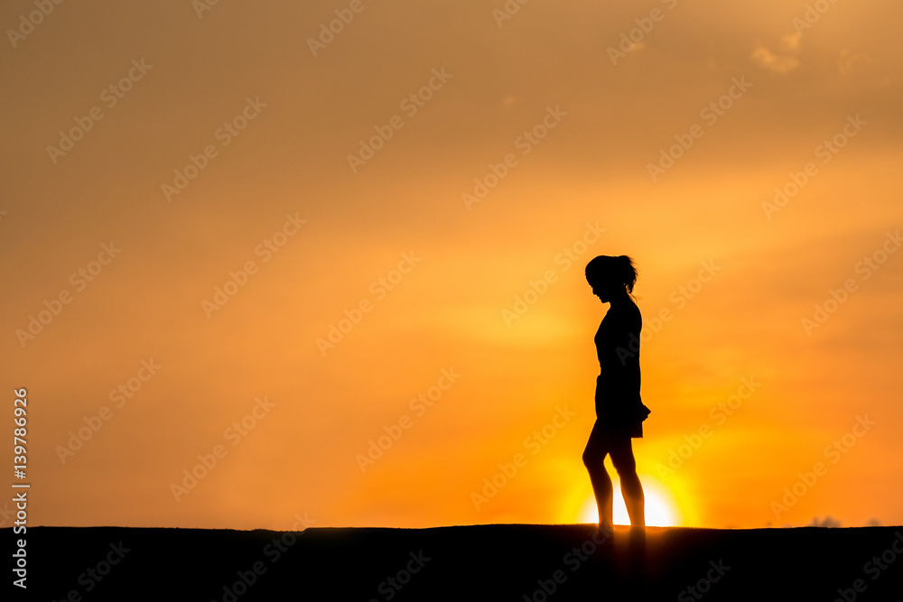 silhouette of Young woman relaxing in summer sunset sky outdoor. People freedom style. silhouette of Young woman relaxing in summer sunset sky outdoor. People freedom style.