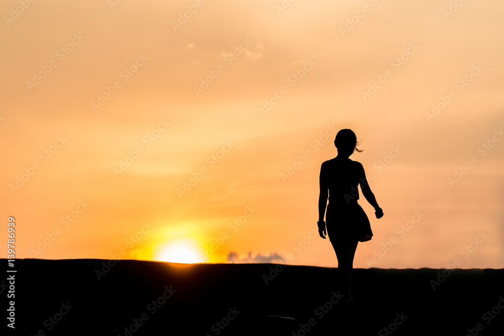 silhouette of Young woman relaxing in summer sunset sky outdoor. People freedom style. silhouette of Young woman relaxing in summer sunset sky outdoor. People freedom style.