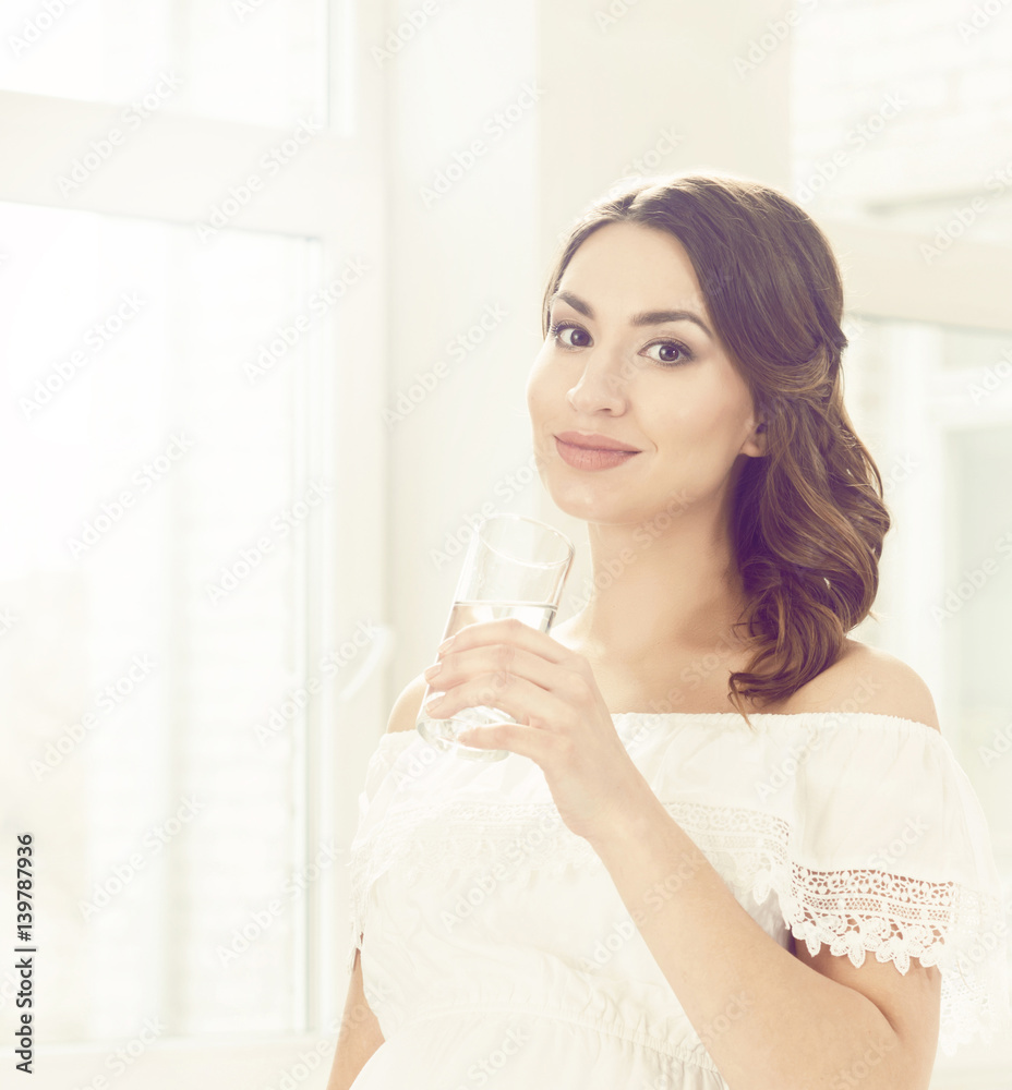 Beautiful, young woman with glass of water. Relaxing at home. Beautiful, young woman with glass of water. Relaxing at home.