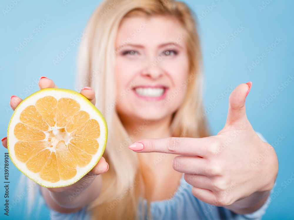 Woman pointing on grapefruit citrus fruit Woman pointing on grapefruit citrus fruit