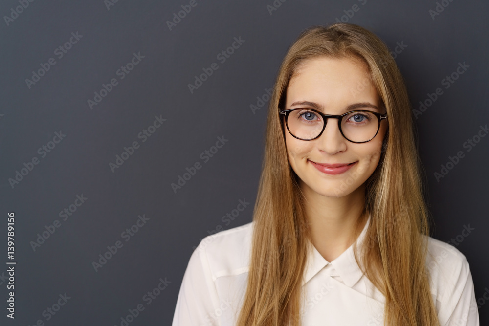 lächelnde frau mit brille vor grauer wand lächelnde frau mit brille vor grauer wand
