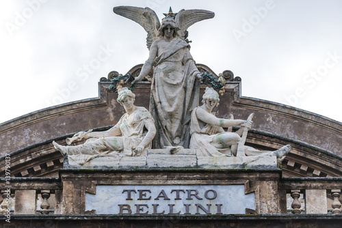 Statue on the roof of Teatro Massimo Bellini opera house in Catania city, Sicily Island, Italy photo