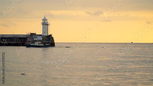 Wallpaper Mural Pier with a lighthouse in the evening. The boat sails past. Slow motion,high speed camera Torontodigital.ca