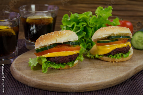 Cheeseburgers on wooden plank