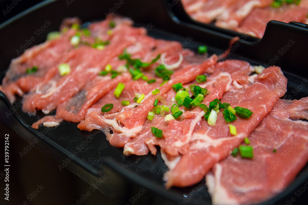 Closeup shabu slice pork with green scallion on top
