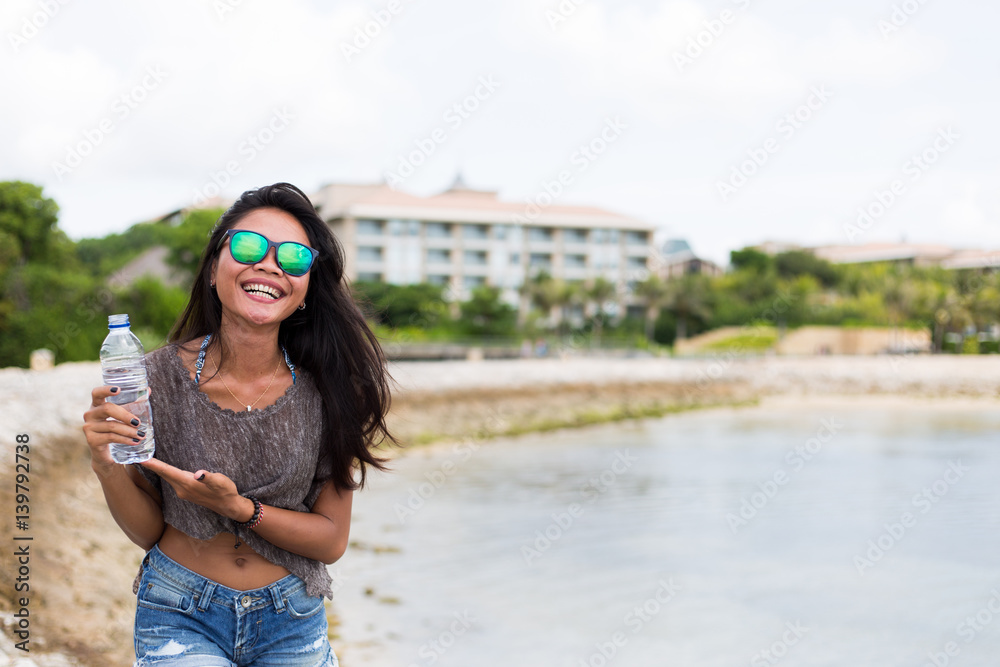 Young adult girl drinking water outdoors concept 