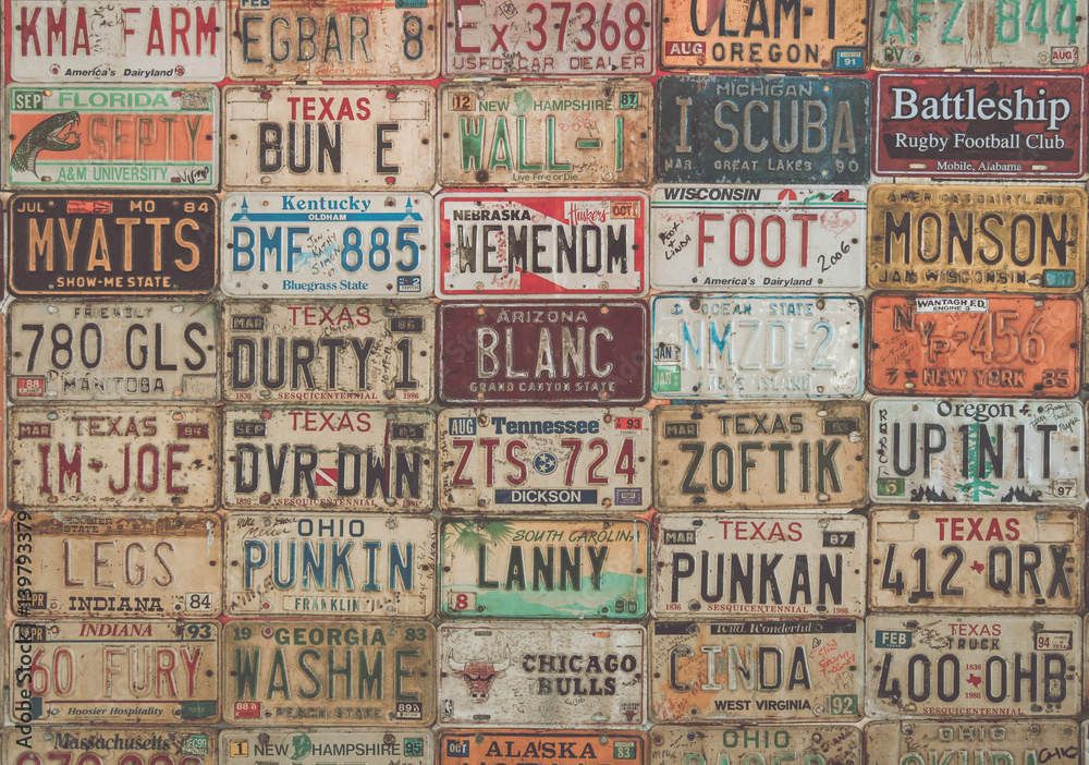 Vintage collage of old American car plates.