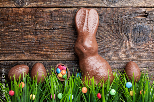 Photography Chocolate Easter bunny and eggs on wooden background
