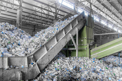Fotografie escalator with a pile of plastic bottles at the factory for processing and recycling