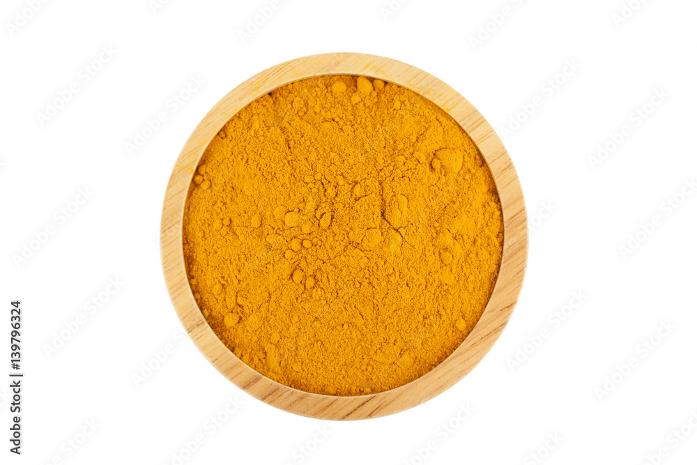 turmeric powder in wooden bowl turmeric powder in wooden bowl