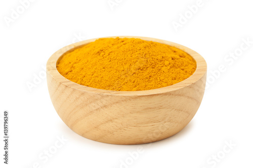 turmeric powder in wooden bowl