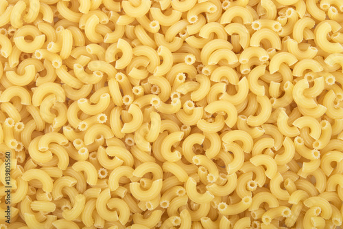 Full background of dry uncooked macaroni pasta