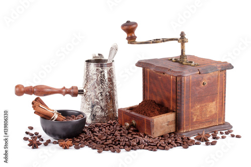 Old coffee grinder maker and coffee beans.
