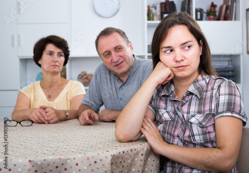 Young woman sitting and looking unhappy indoors