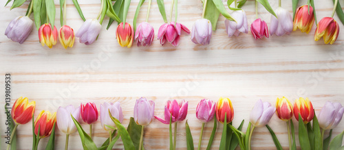 bouquet of tulips of spring flowers on old wooden board on holiday of Easter