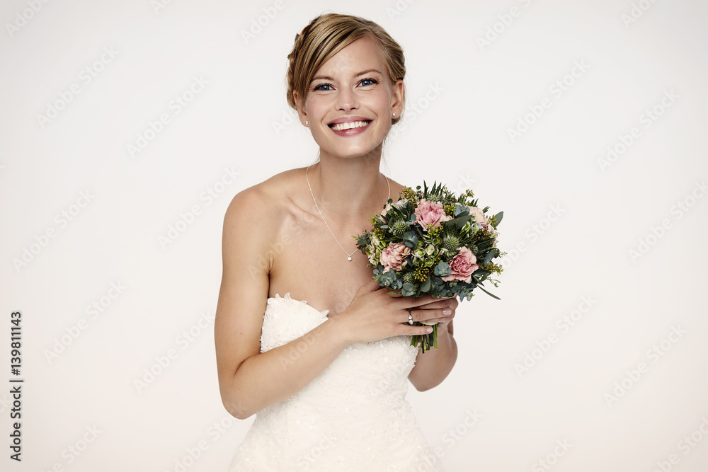 Gorgeous bride holding flowers, portrait