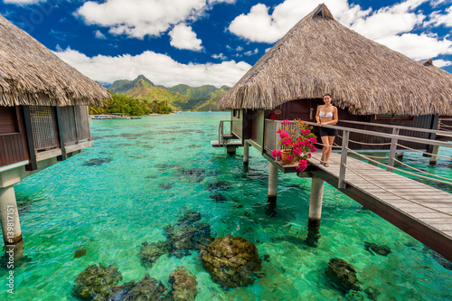 Young woman in front of luxury over water bungallows