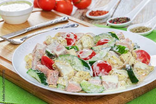 salad with meat, cucumber, tomato, cheese, omelette