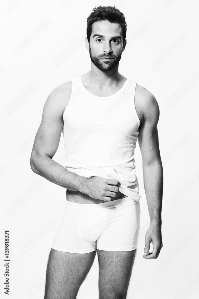 Fototapeta premium Underwear guy posing in shorts and vest, portrait
