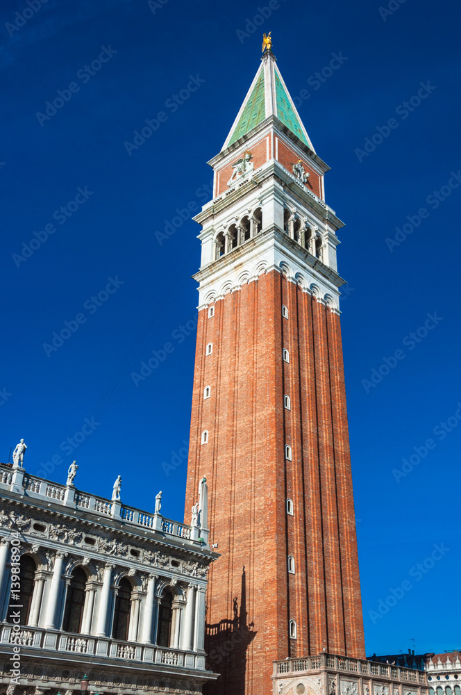 The Belltower on the St. Mark Square against blue sky in Venice