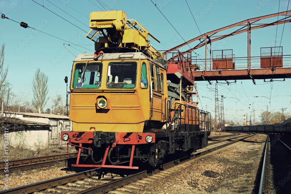 Fototapeta premium Yellow Railway track service car fixing the railroad.Toned image.