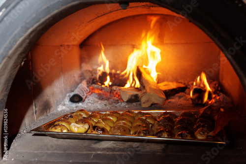 Apples being roasted in wood stove