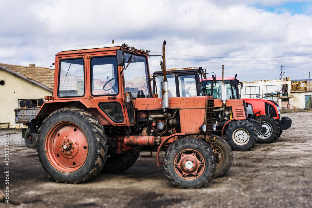 Closeup of tractors after plowing. Wheels covered with mud. Agronomy, agriculture,concept. Closeup of tractors after plowing. Wheels covered with mud. Agronomy, agriculture,concept.